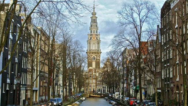 church viewed from canal bridge amsterdam